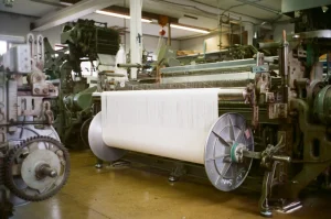 Industrial weaving looms producing fabric