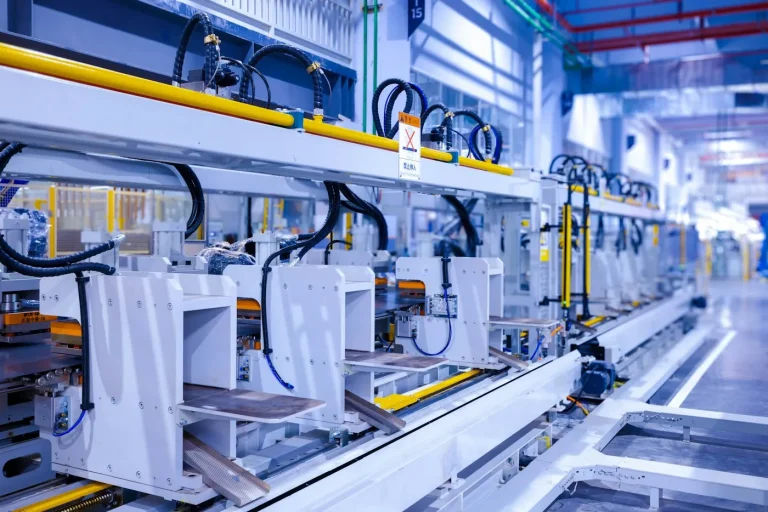 Workers operating an automated manufacturing line