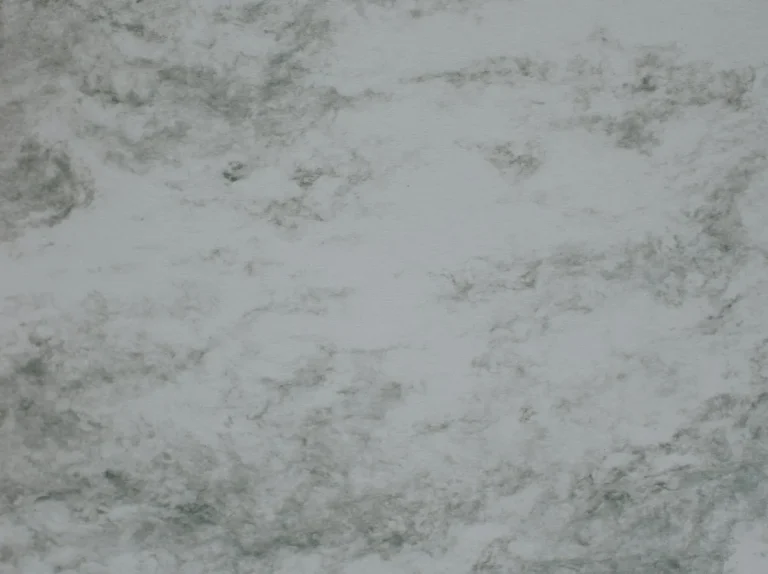 Close-up of polished white marble slab with grey veining