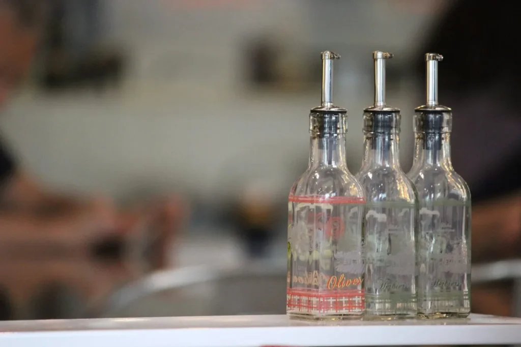 Glass bottles of olive oil lined up for packing