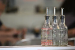 Glass bottles of olive oil lined up for packing