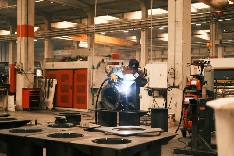 Welder joining steel sections with sparks flying